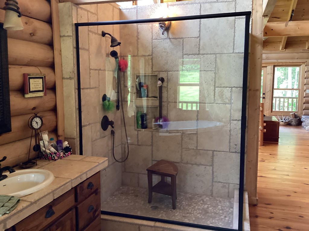 Master tiled shower with pebble stone bottom